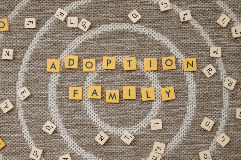 Scrabble tiles spell the words "Adoption Family"